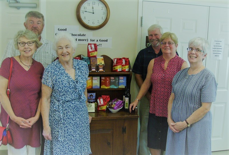 A group of elderly churchgoers show off the fair trade products they plan to bring to farmers market.