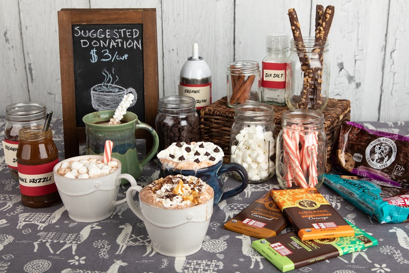 A hot cocoa bar with finished cups of cocoa