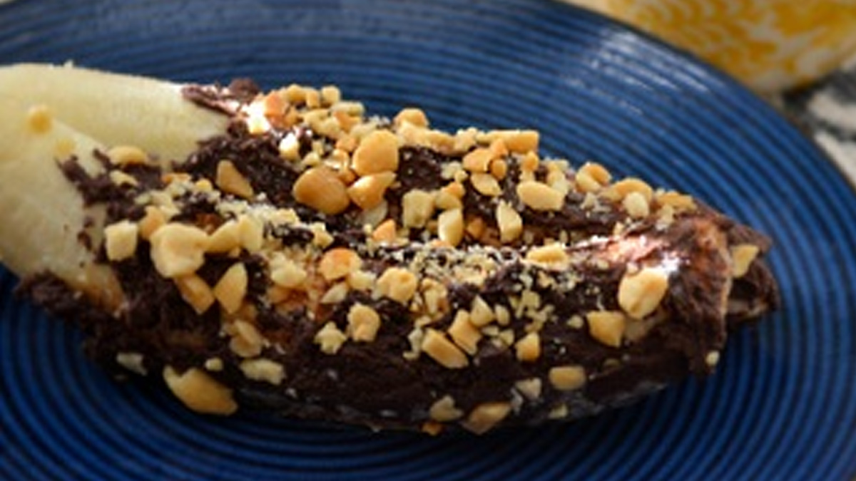 Frozen banana covered in chocolate and nuts