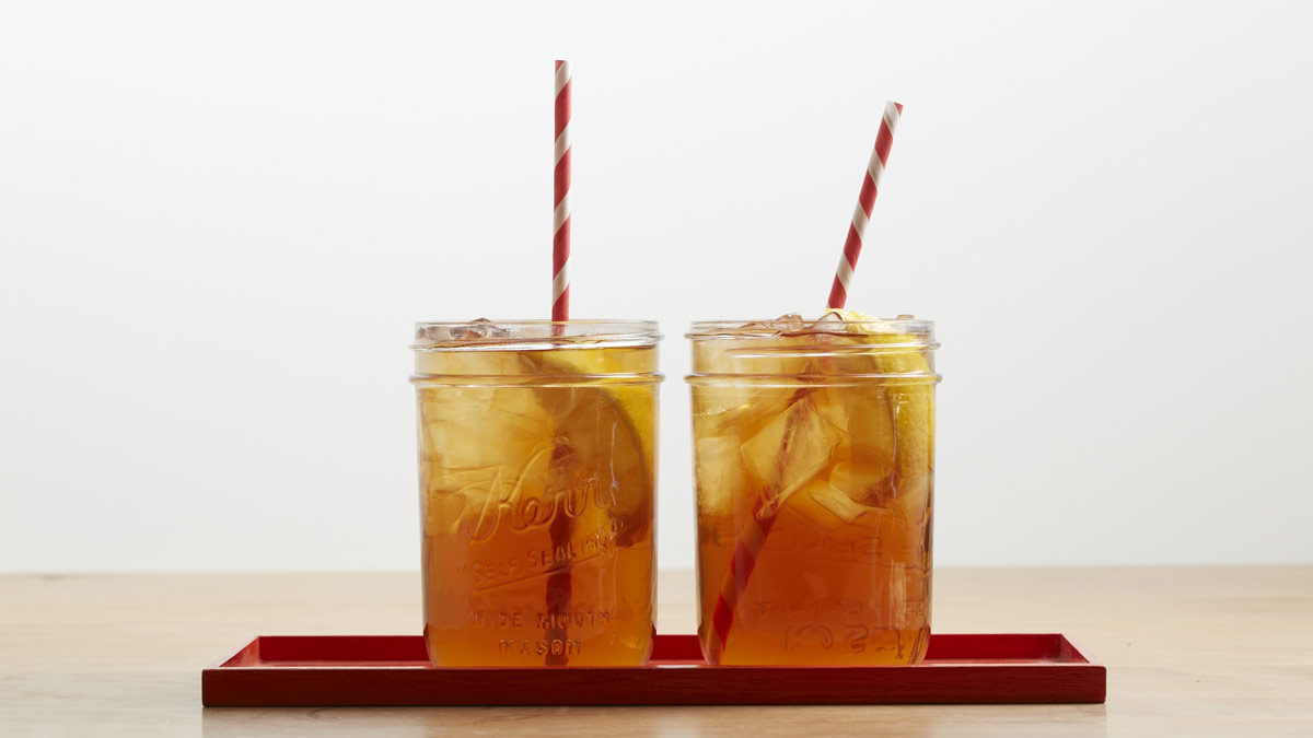 Red and black iced tea with striped straws