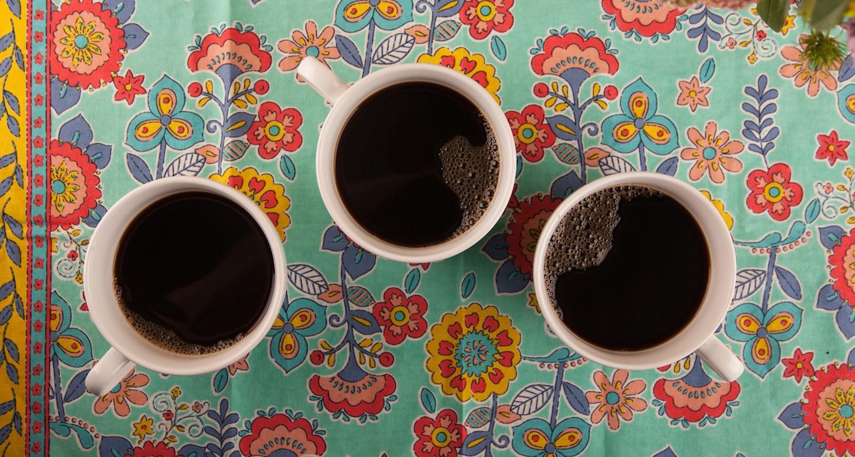 Cups of Organic coffee on a bright tablecloth