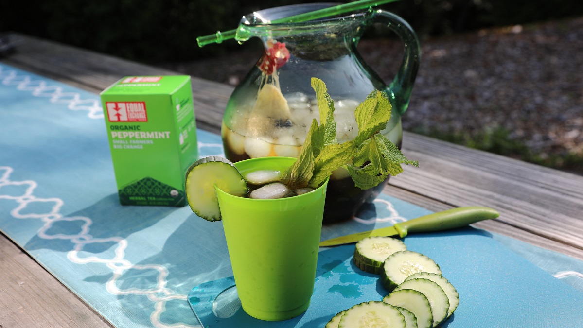 A pitcher of mint tea with sliced cucumber