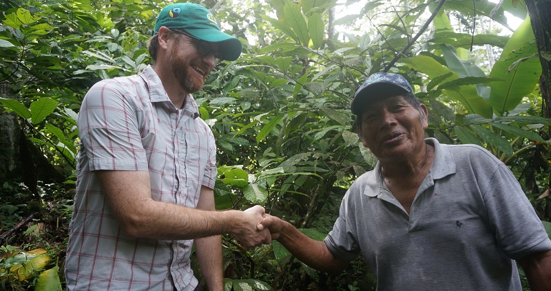 Two men, members of different co-ops, shake hands