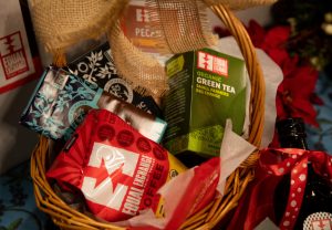 Wicker gift basket with green tea, coffee, chocolate bars and pecans