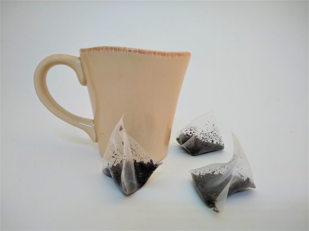 A mug with three mesh tea bags made from plastic