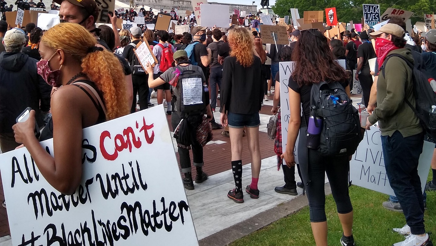 A group of protestors hold "Black Lives Matter" signs