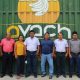 Eight directors standing in front of the AVACH warehouse